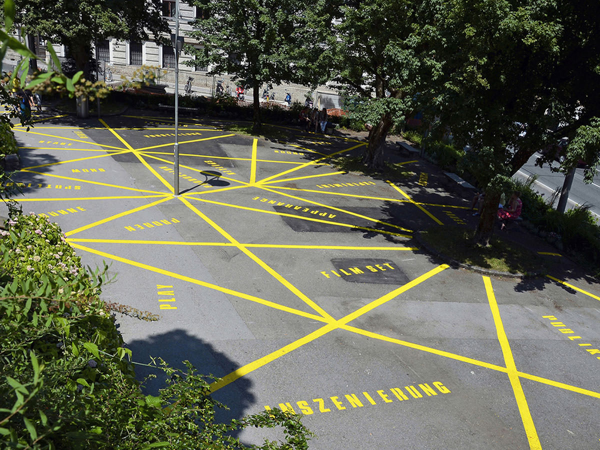 Gelbe Bodenmarkierungen auf einem Platz
